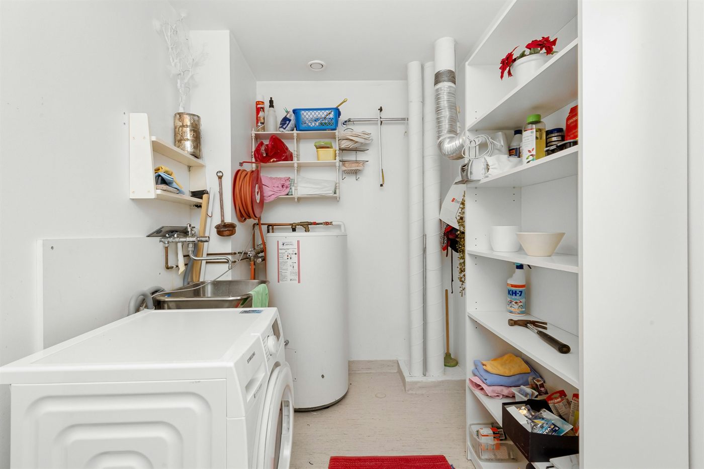 Residential utility room with a tank water heater